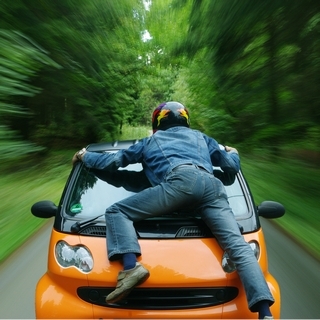 Motorcyclist On Car Bonnet