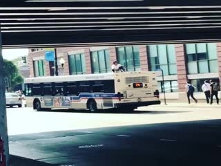 Guy Rides On Top Of A Bus