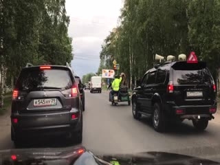 Bear Rides Motorcycle And Waves To People