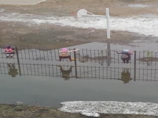 Children Scale Fence To Avoid Flooding To Get To School
