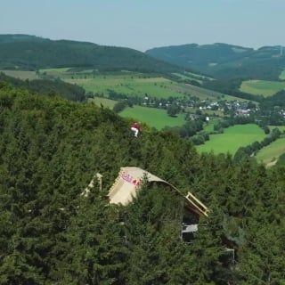 Fedko's 24-meter-high aerial mountain bike jumps above the trees