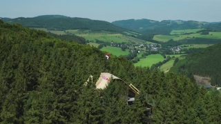 Fedko's 24-meter-high aerial mountain bike jumps above the trees